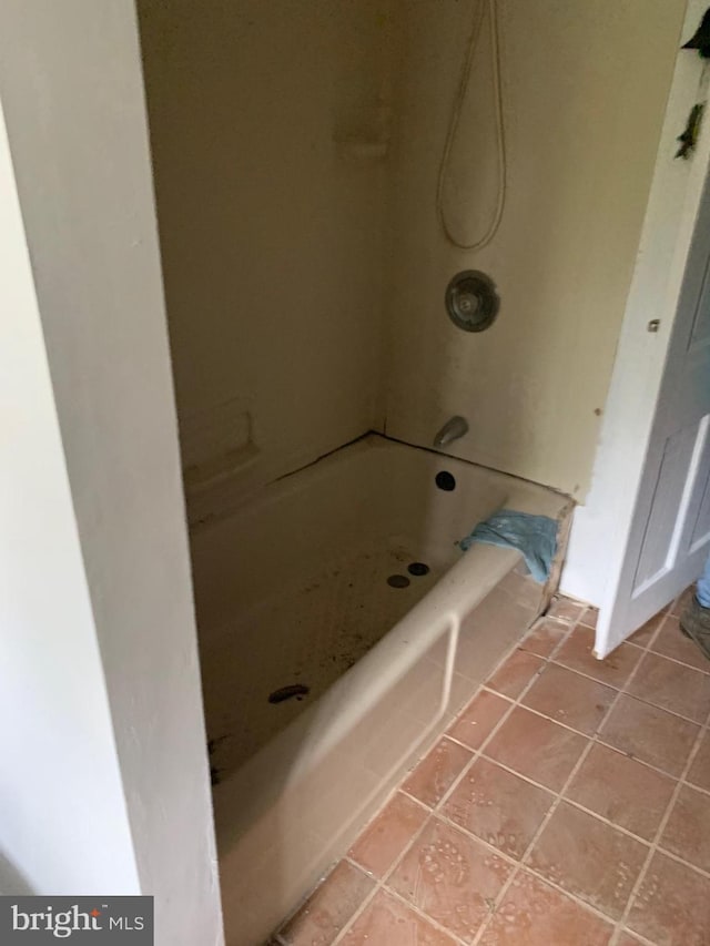 bathroom featuring tiled shower / bath combo and tile flooring