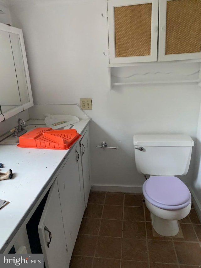 bathroom with toilet, tile floors, and oversized vanity