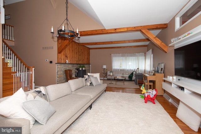 living room featuring high vaulted ceiling, beamed ceiling, a chandelier, and light hardwood / wood-style floors