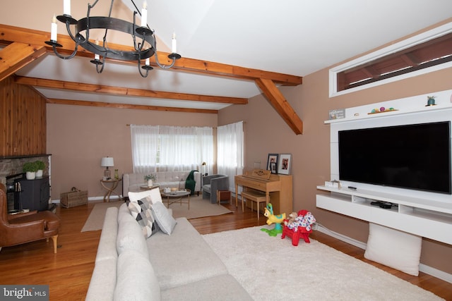 living room featuring a notable chandelier, vaulted ceiling with beams, and light hardwood / wood-style floors