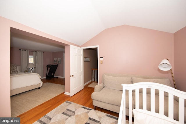 bedroom with light hardwood / wood-style flooring and lofted ceiling