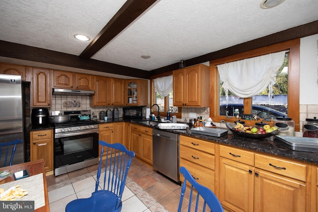 kitchen featuring light tile floors, appliances with stainless steel finishes, tasteful backsplash, and sink