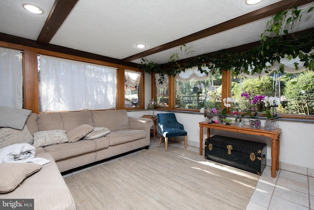 tiled living room with a textured ceiling and beamed ceiling