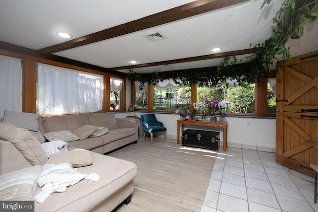 tiled living room featuring beam ceiling