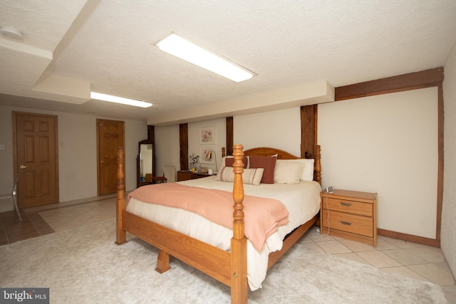 tiled bedroom with a textured ceiling