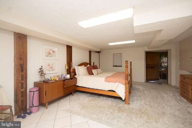 bedroom featuring a textured ceiling and light tile floors