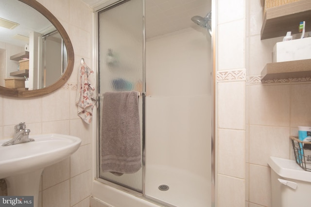 bathroom with tile walls and toilet