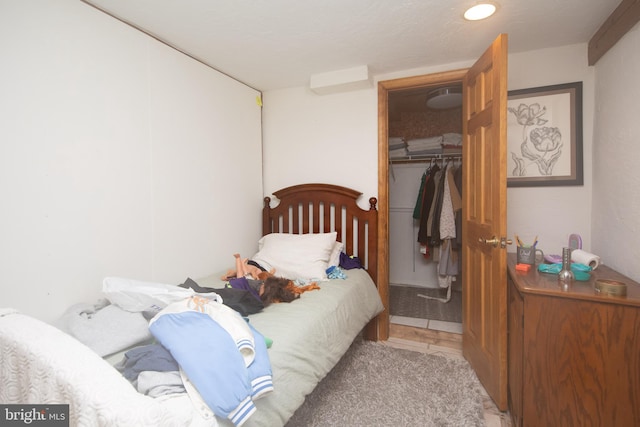 bedroom with light tile floors and a closet