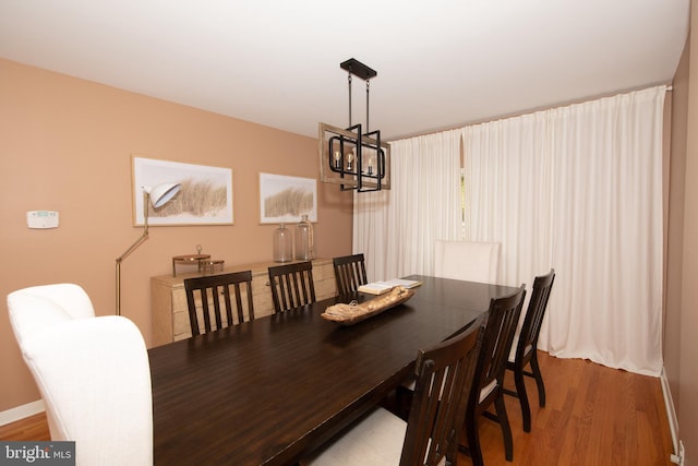 dining room with an inviting chandelier and light hardwood / wood-style flooring