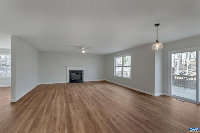 unfurnished living room with light hardwood / wood-style floors and ceiling fan