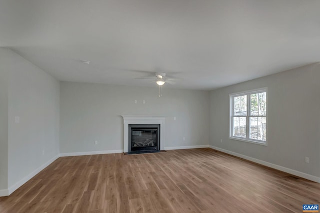 unfurnished living room with ceiling fan and light wood-type flooring