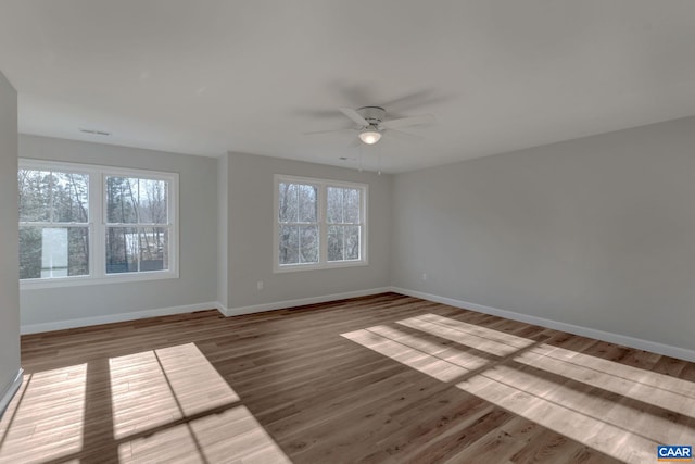 spare room with plenty of natural light, light hardwood / wood-style floors, and ceiling fan