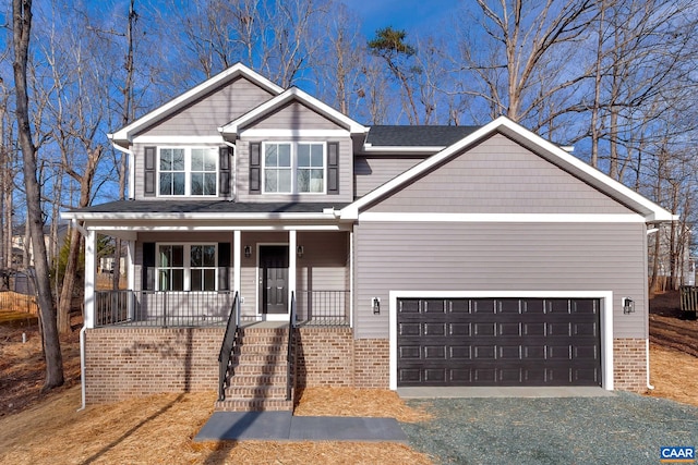 view of front of house with covered porch and a garage