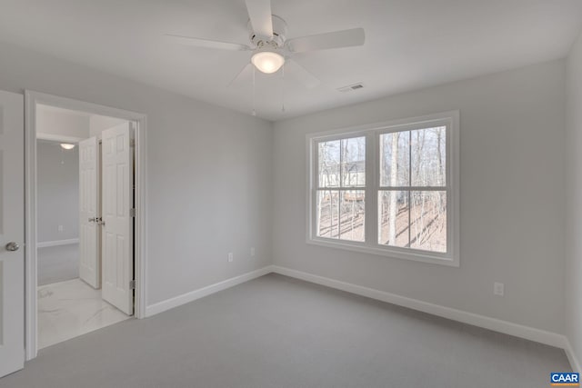 unfurnished room featuring light carpet and ceiling fan