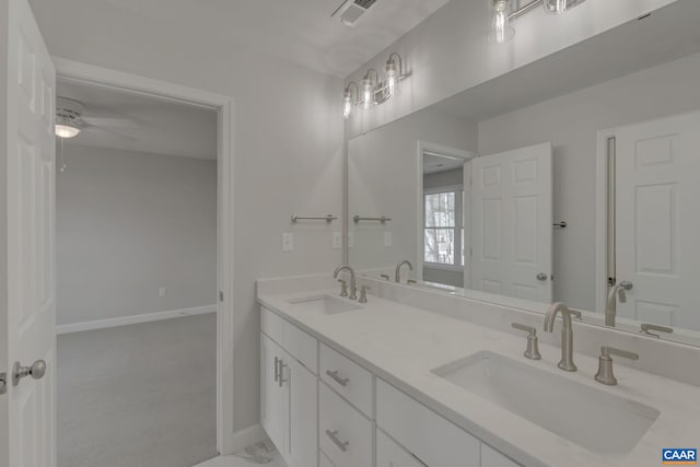 bathroom with ceiling fan and double vanity