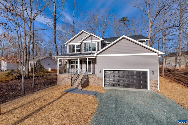 view of front facade featuring a porch and a garage