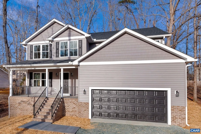 view of front of house with covered porch and a garage