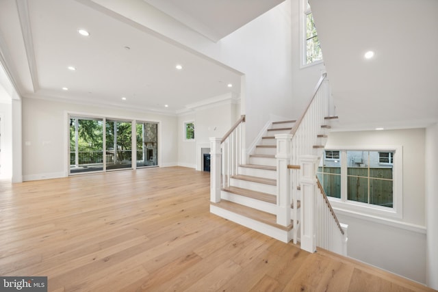 interior space with light hardwood / wood-style flooring and ornamental molding