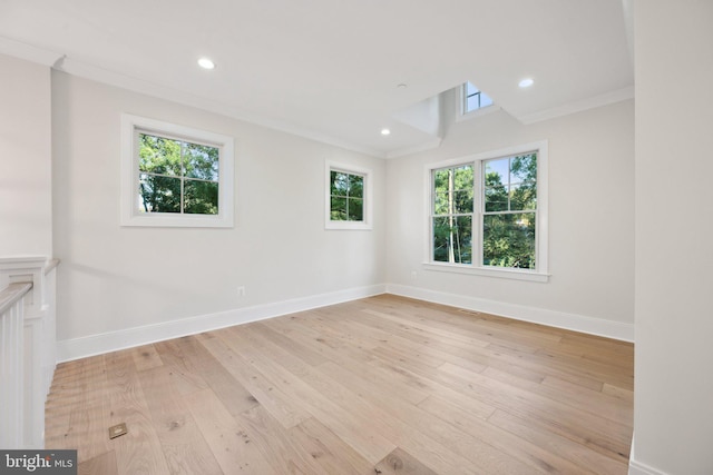 unfurnished room featuring ornamental molding and light wood-type flooring