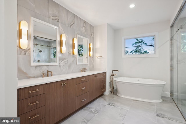 bathroom with tasteful backsplash, vanity, separate shower and tub, and tile walls