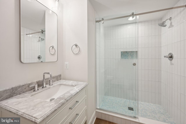 bathroom with an enclosed shower and vanity