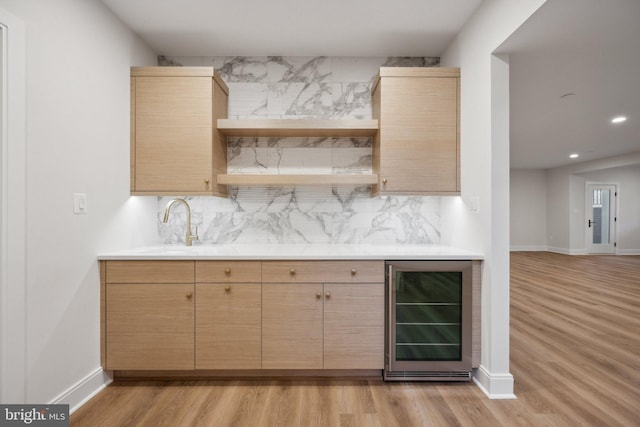 bar with wine cooler, light brown cabinetry, and tasteful backsplash