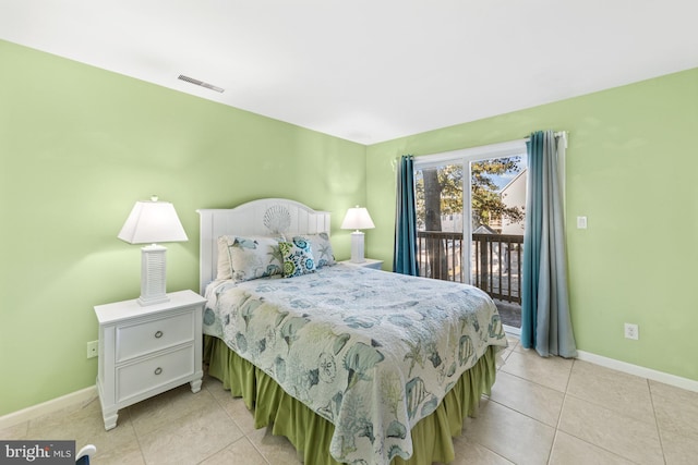 bedroom with light tile floors and access to outside