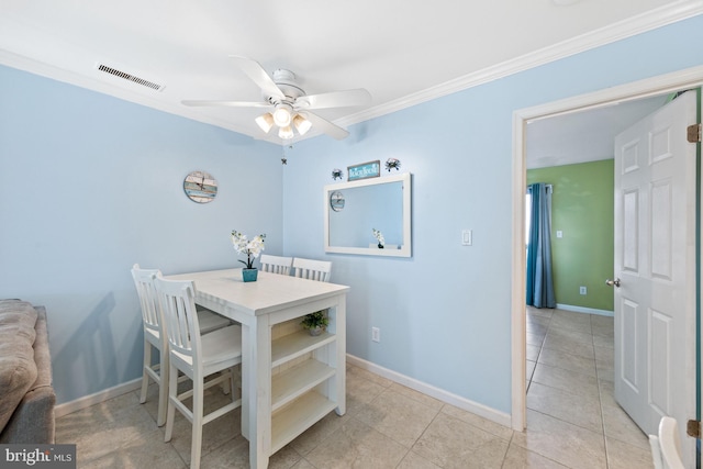 tiled dining room featuring ceiling fan and ornamental molding