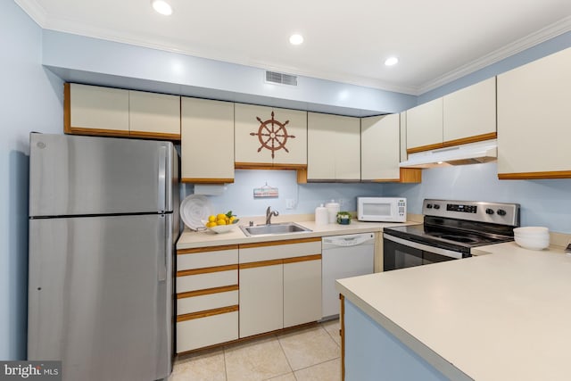 kitchen featuring crown molding, light tile floors, appliances with stainless steel finishes, and sink