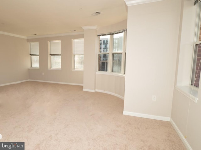 unfurnished room featuring light colored carpet and crown molding