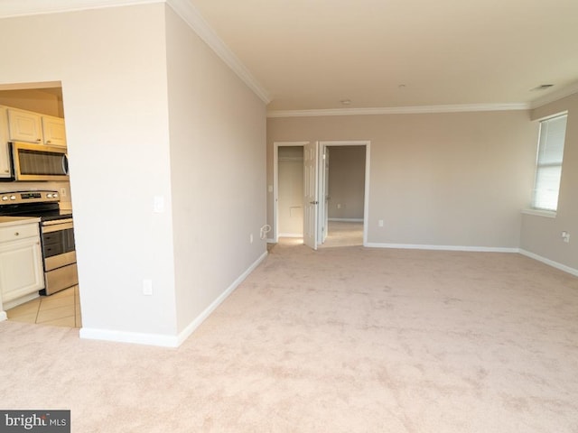 empty room featuring ornamental molding and light colored carpet