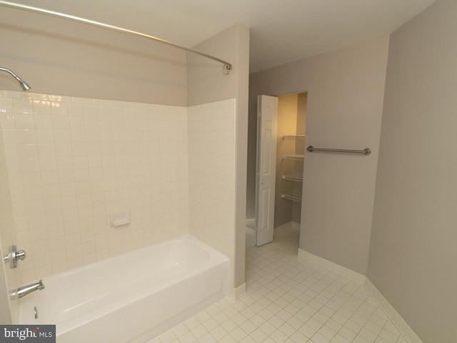 bathroom featuring tile flooring and bathtub / shower combination