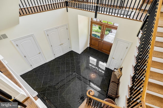 entryway featuring a towering ceiling