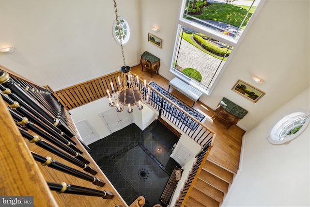 interior space featuring a notable chandelier and a towering ceiling