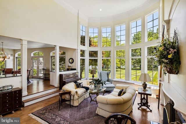 sunroom with decorative columns and a chandelier