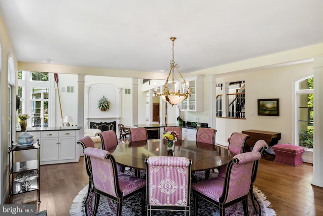 dining room with dark hardwood / wood-style flooring, sink, and an inviting chandelier