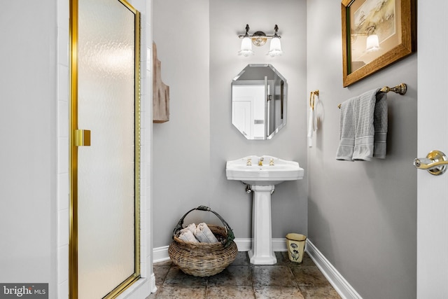 bathroom featuring tile flooring and a shower with shower door