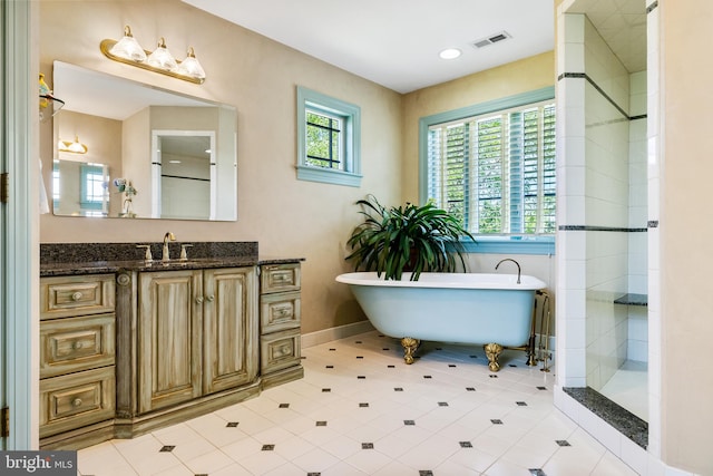 bathroom with separate shower and tub, tile floors, and vanity