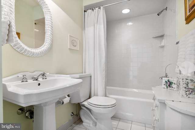 bathroom with toilet, shower / tub combo with curtain, and tile flooring