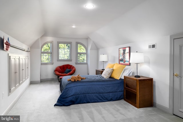 carpeted bedroom with vaulted ceiling