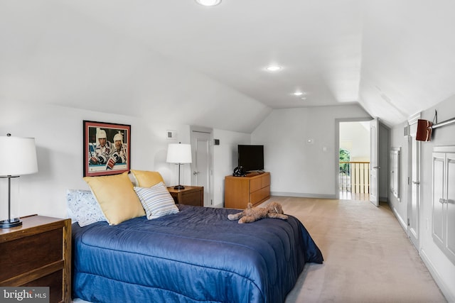 bedroom featuring lofted ceiling, light carpet, and access to outside