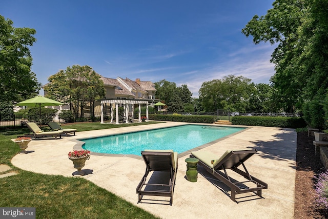 view of pool featuring a pergola, a lawn, and a patio area