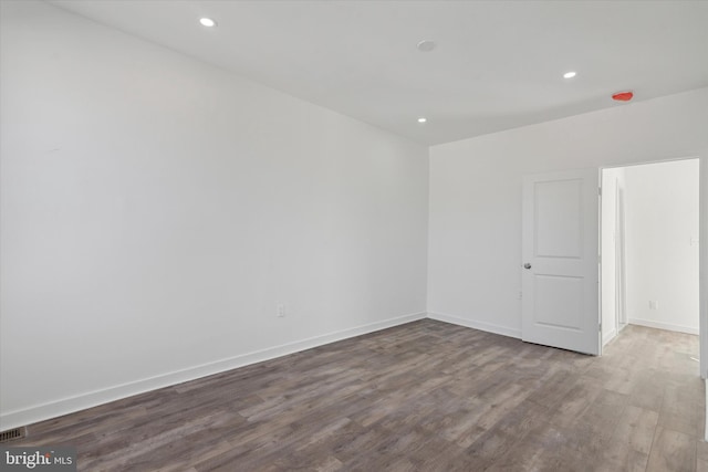 unfurnished room with hardwood / wood-style floors