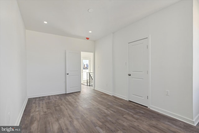 empty room featuring dark wood-type flooring