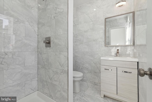 bathroom with tile walls, tile flooring, and tiled shower