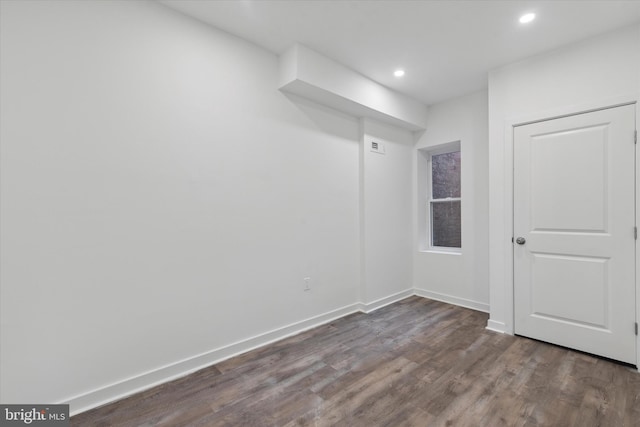 spare room with dark wood-type flooring