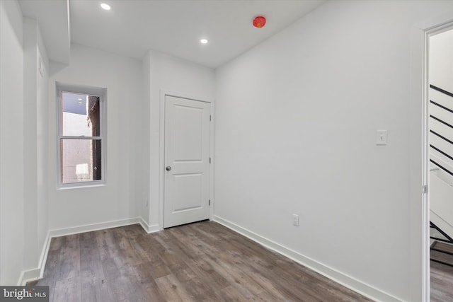 spare room with dark hardwood / wood-style flooring