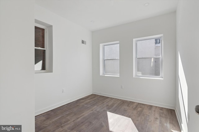 spare room with dark wood-type flooring