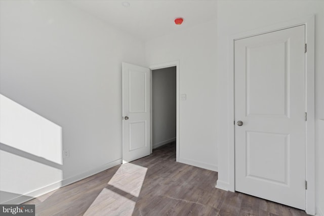 unfurnished bedroom featuring dark wood-type flooring