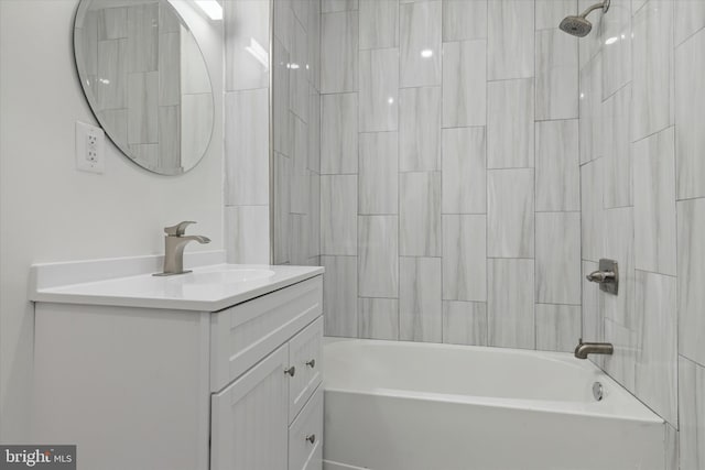 bathroom featuring tiled shower / bath combo and large vanity